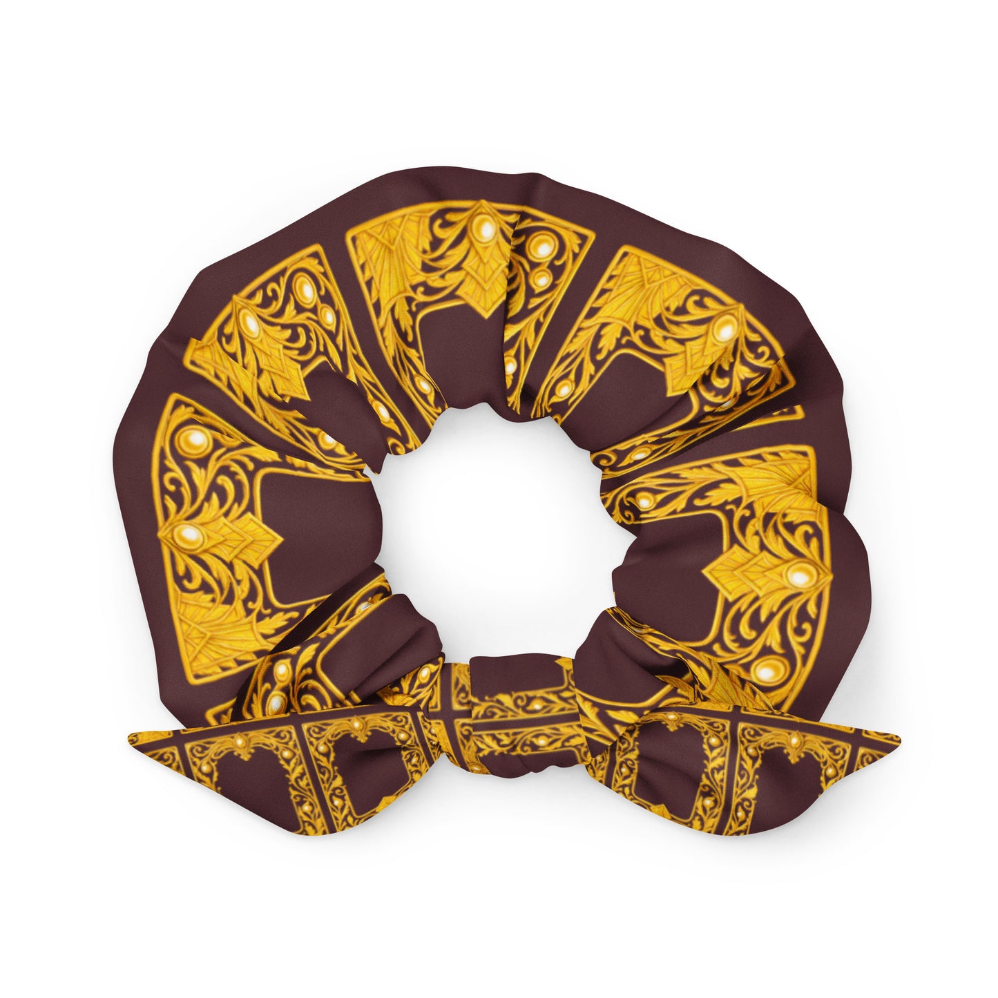 Brown recycled material scrunchie with decorative repeated gold ornate pattern on a white background