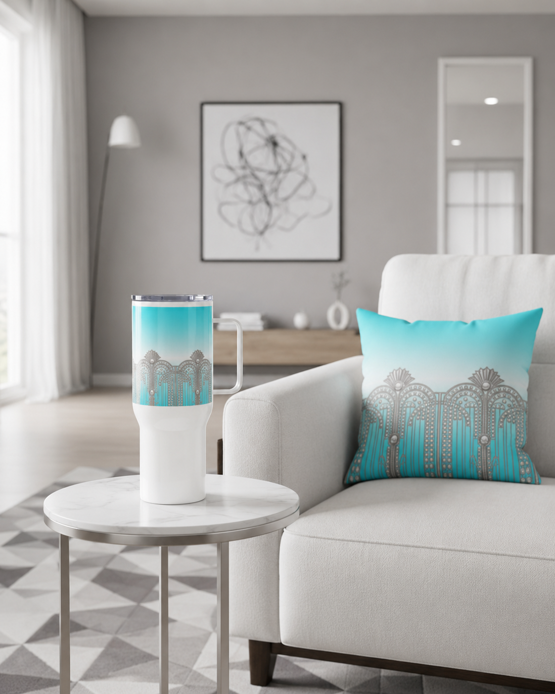 ARTEMI ARTELIA tumbler and cushion in matching sky blue with Art Deco silver motifs — styled on a side table and sofa in a contemporary living room.