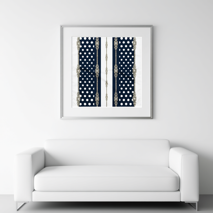 Framed artwork with a pattern of blue and white polka dots and silver antique rhinestone accents above a pure white sofa.
