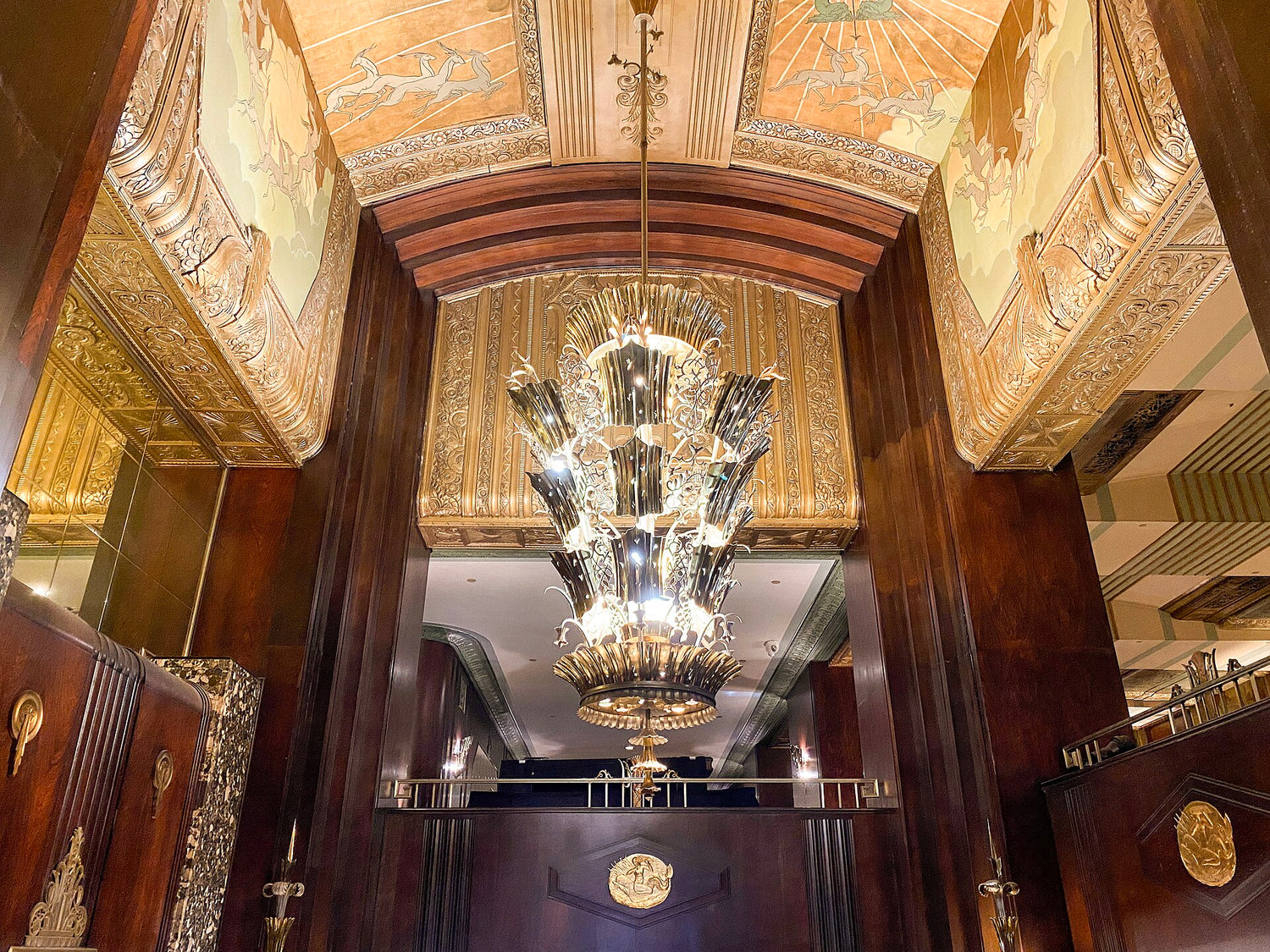 Exquisite Art Deco gold color engraved ceiling and metallic chandelier detail at the Netherlands Plaza Hotel, Cincinnati, housed within the Carew Tower.