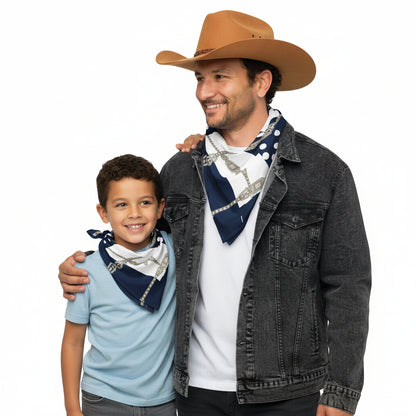 Man wearing a denim jacket and white shirt with a blue patterned scarf, on a white background. Next to him is a son smiling, wearing the same bandana.