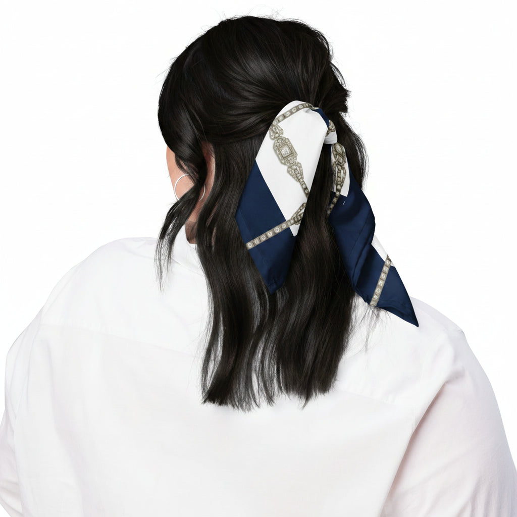 Person with black shiny hair, tied back with a decorative navy blue & white scarf tied in a ribbon shape. Back view shot.