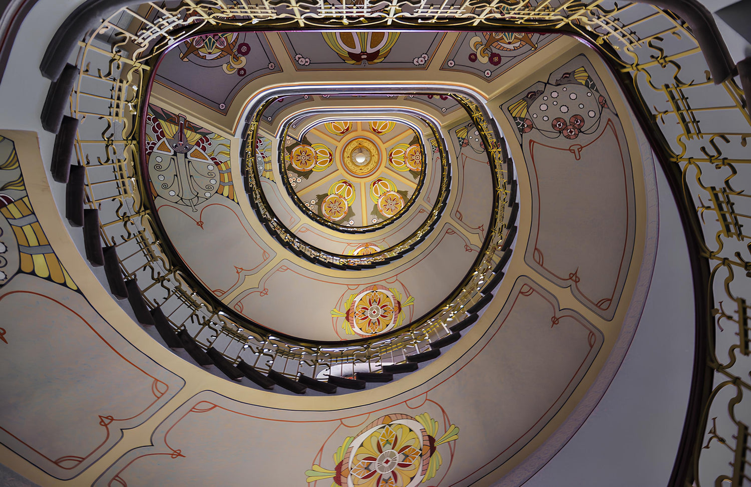 Ceiling view of the spiral staircase at the Riga Art Nouveau Museum, renowned for its Art Nouveau, Jugendstil architecture and gallery.