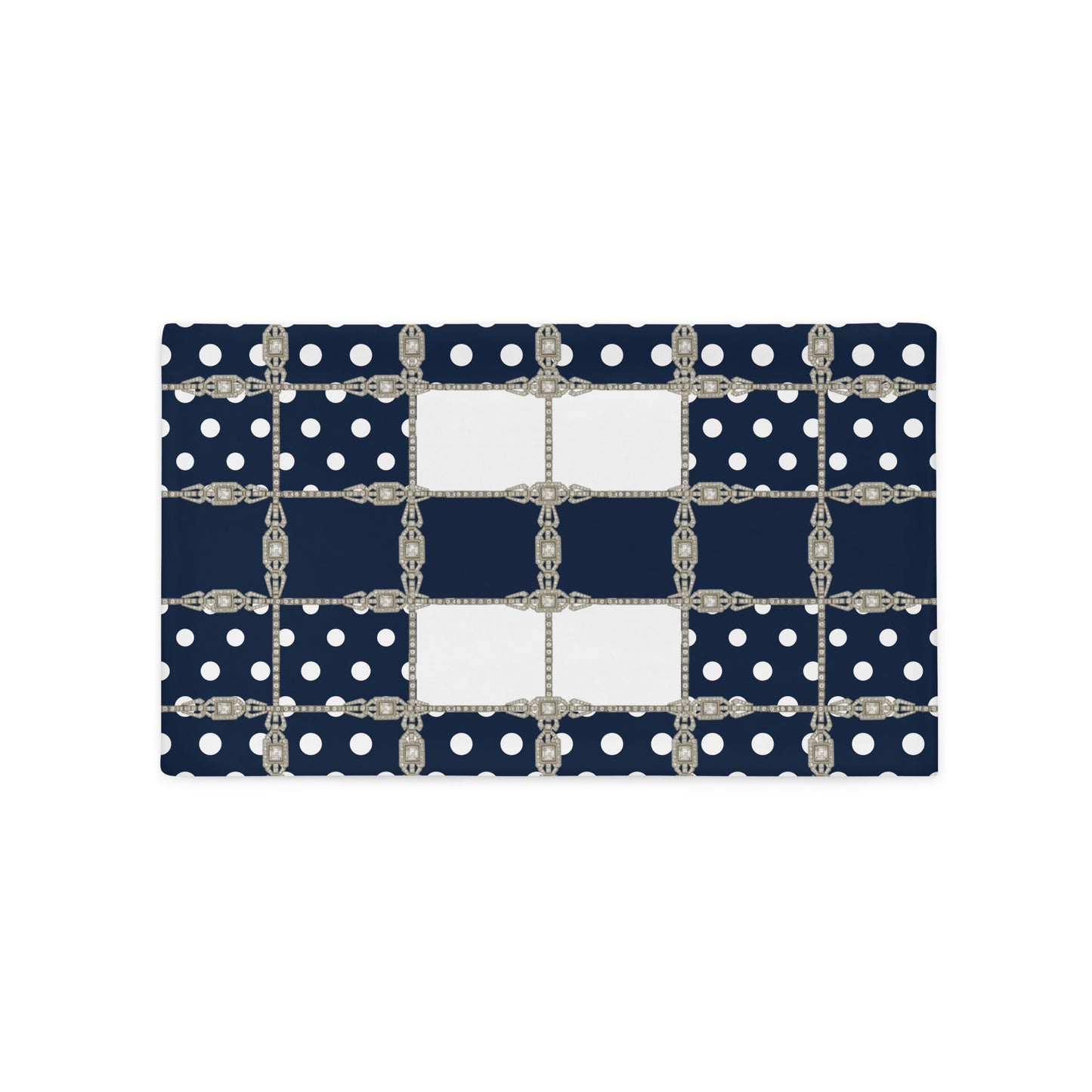Navy blue cushion cover with white polka dots and silver Art Deco chain details on a white background