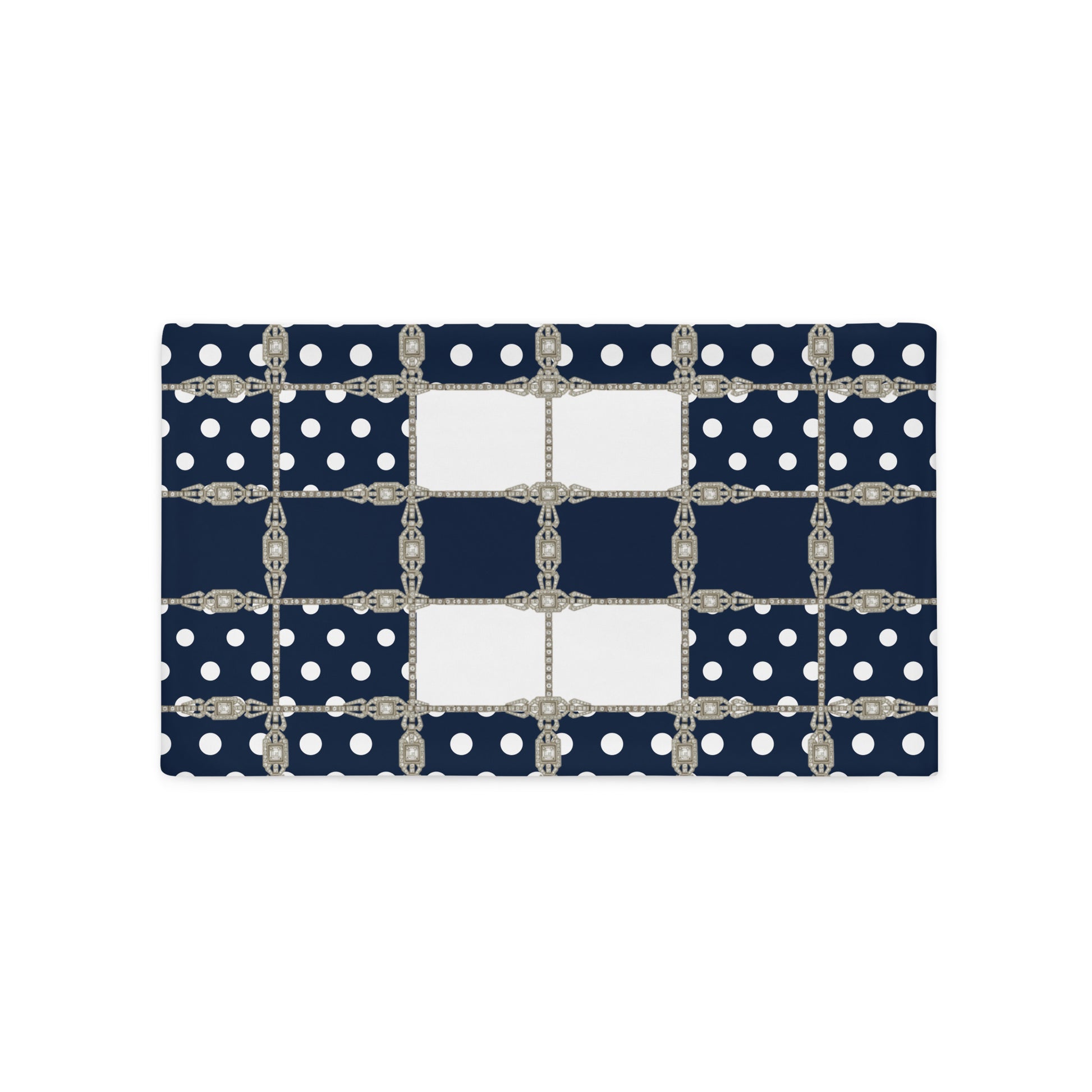 Navy blue cushion cover with white polka dots and silver Art Deco chain details on a white background