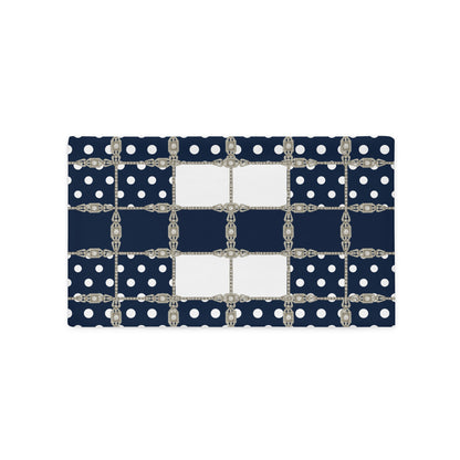 Navy blue cushion cover with white polka dots and silver Art Deco chain details on a white background
