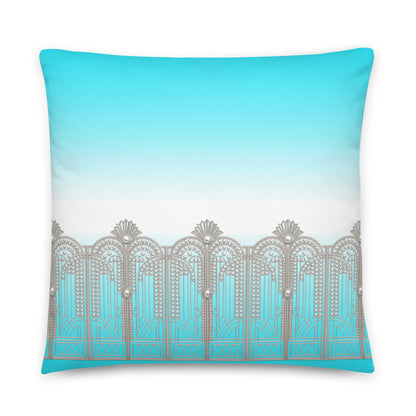 A square throw pillow featuring a printed design of a silver Art Deco style gate against a turquoise and white gradient background.