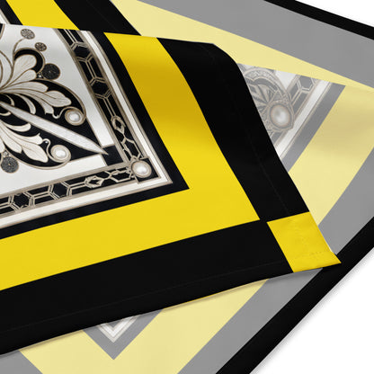 A square scarf corner featuring a bold Art Deco style design with a central black, white, and silver geometric motif, surrounded by a wide yellow border and a black outer border with yellow corner accents.