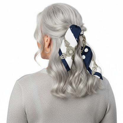 Person with silver semi-long hair, photographed from behind, wearing a navy blue scarf with white polka dots tied as a half-up hair wrap.