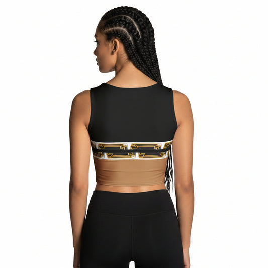 Woman wearing a black sports crop top with gold accents inspired by Egyptian pharaoh motif and black leggings on a white background