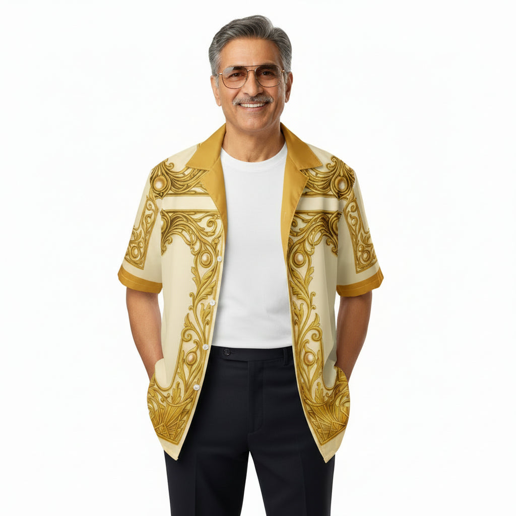 A woman modeling a short-sleeve open-front shirt jacket with a cream base and ornate gold baroque-style border print, worn over a white t-shirt and blue jeans against a plain white background.
