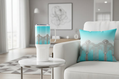 Sky blue tumbler and cushion in matching Art Deco silver motifs — styled on a side table and sofa in a contemporary living room.